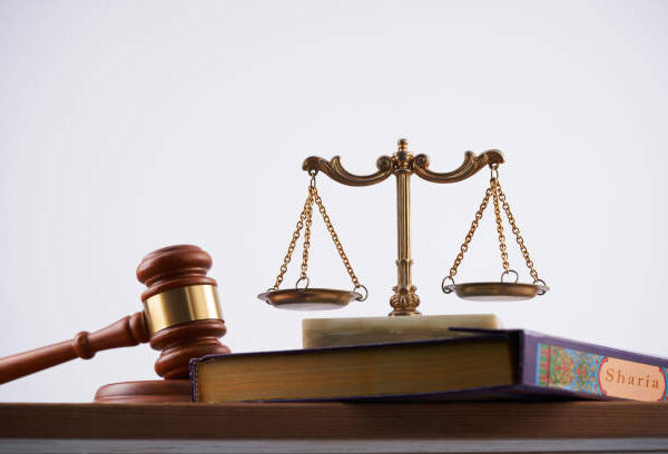 gavel hammer and holy koran against white background - sharia law concept